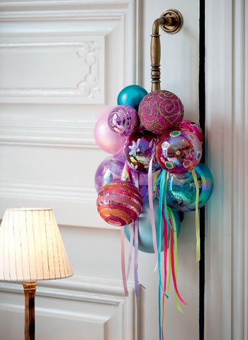 create a garland with ribbon and ornaments