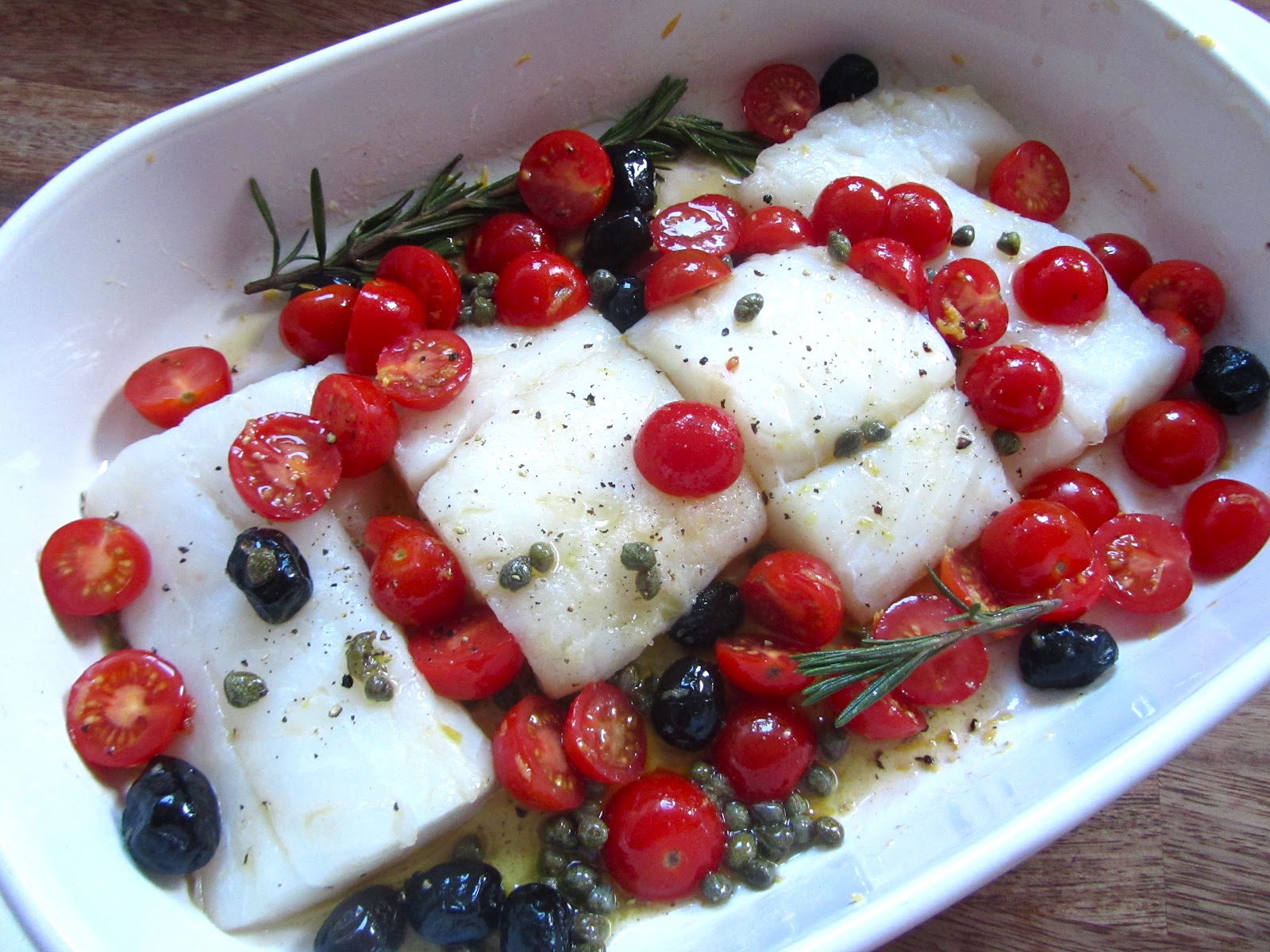 Roasted cod with prosciutto, cherry tomatoes and olives