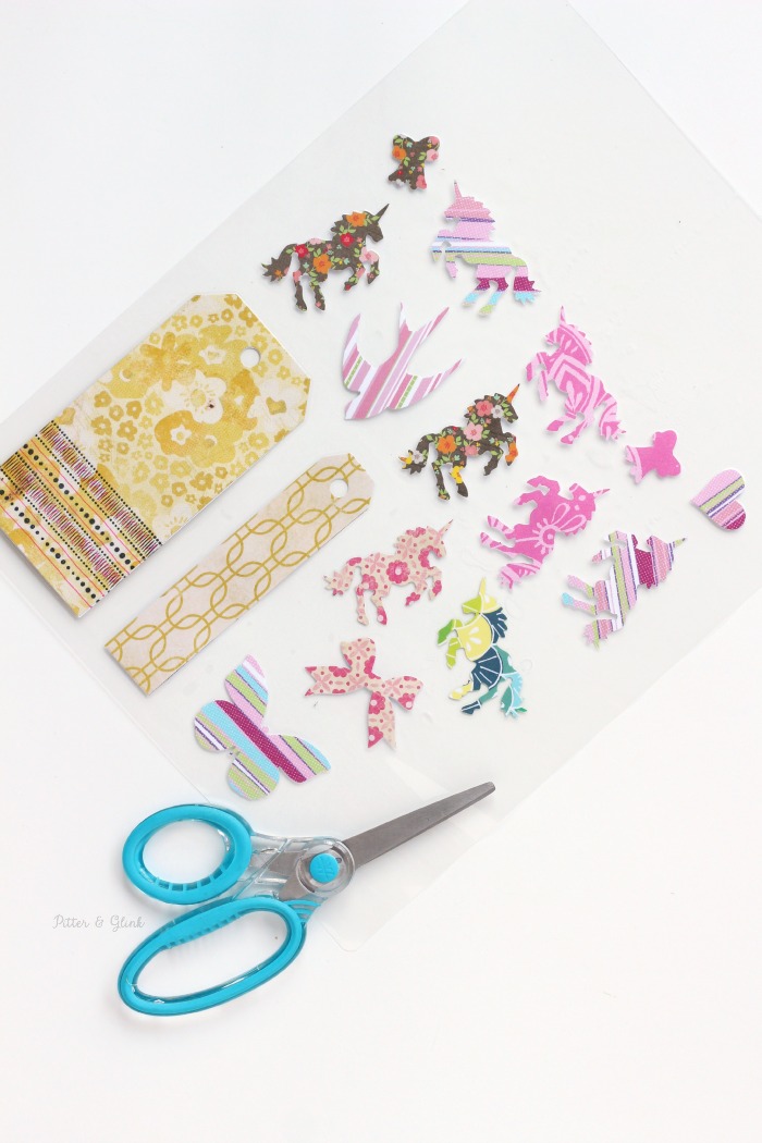 Laminating paper shapes to use for handmade planner clips. www.pitterandglink.com