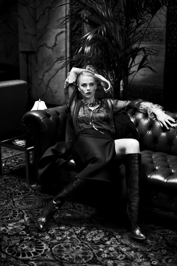 black and white image with Charlize Theron sitting on a couch