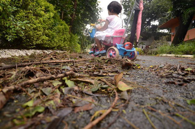Kecil on bike with road debris foreground