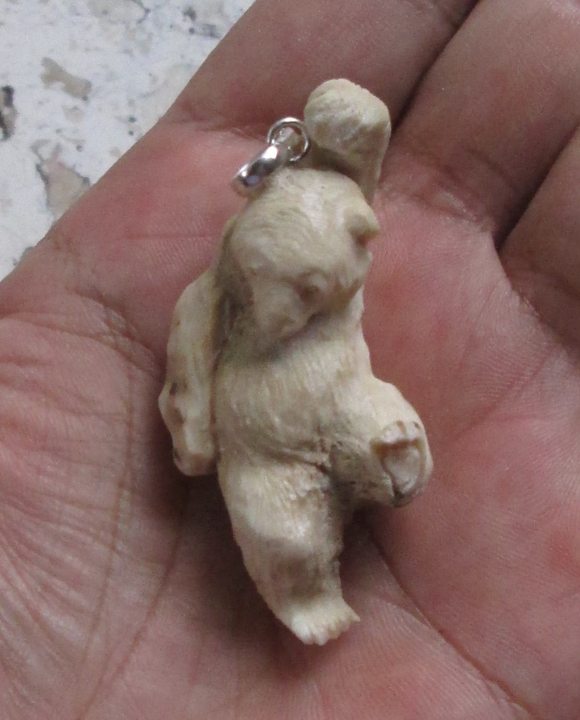 Carved Bear Bone Pendants in Antler Carved Bear Bone Pendants in Antler