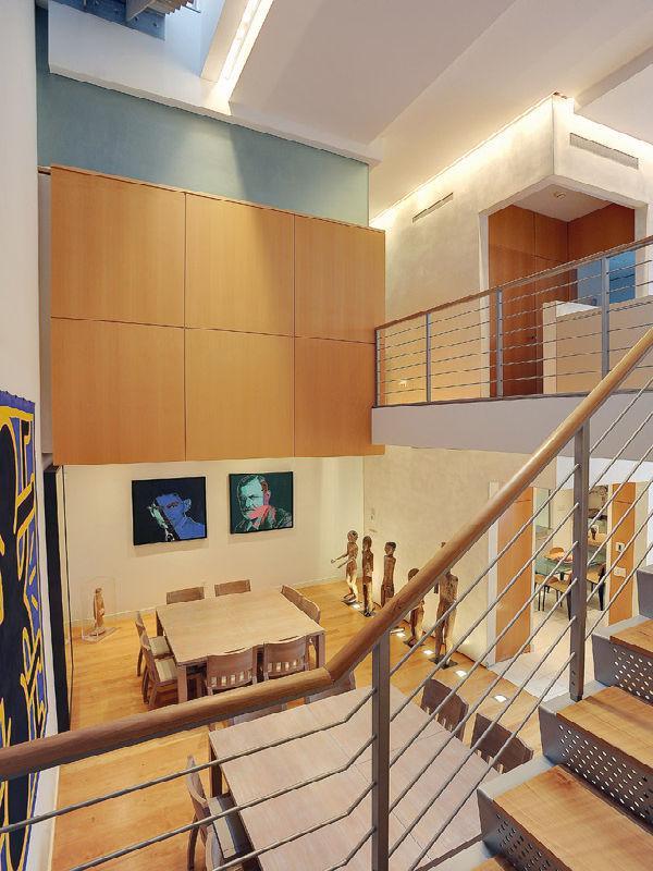 Warm West Village Apartment, New York View of dinning room from the stairs up to the gallery in the West Village Apartment, New York