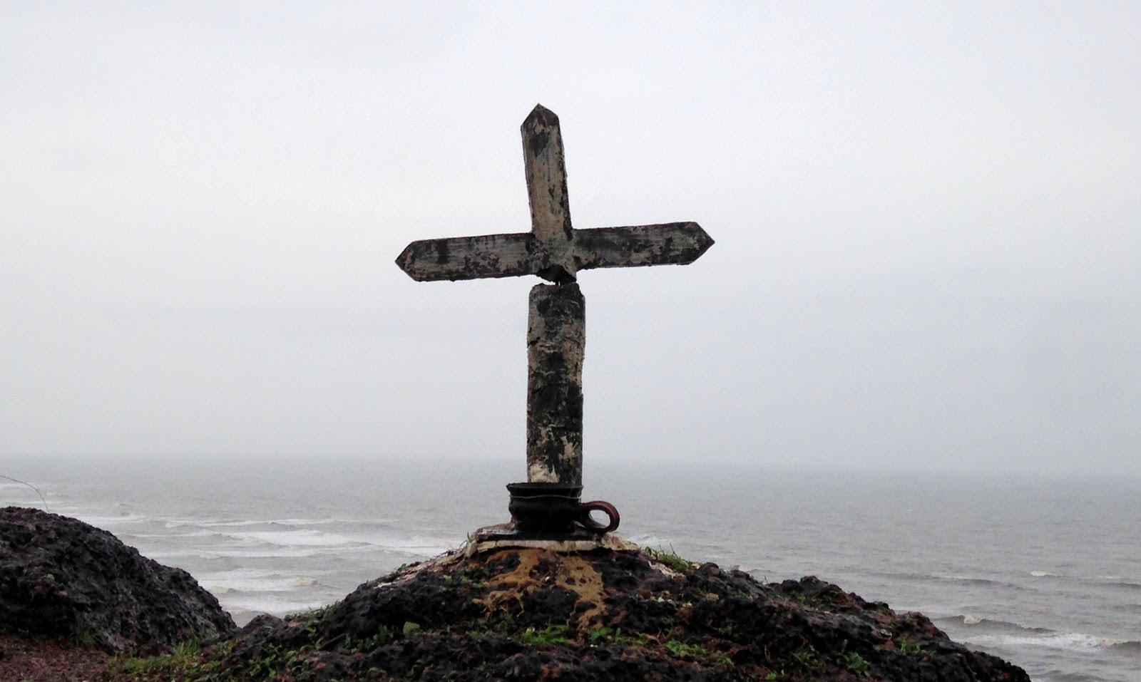 Monsoon drive in western ghats A small cross installed atop the hill