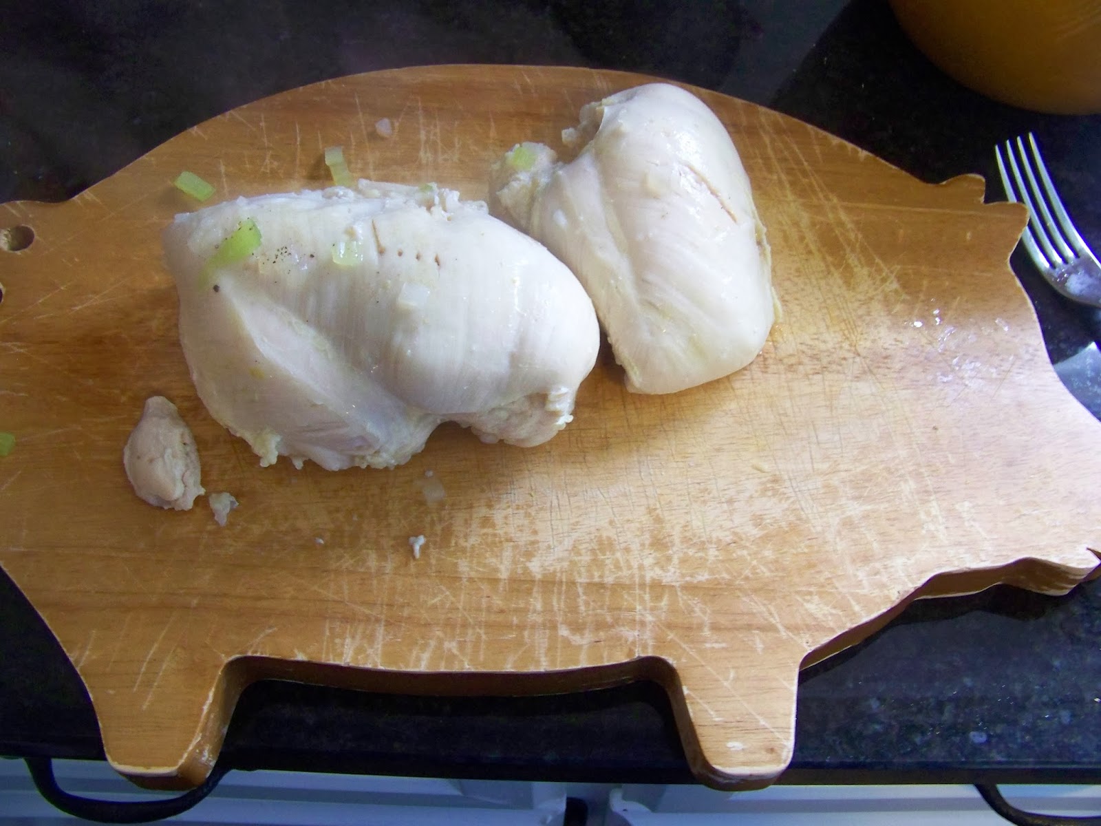 cooked chicken sitting on a cutting board