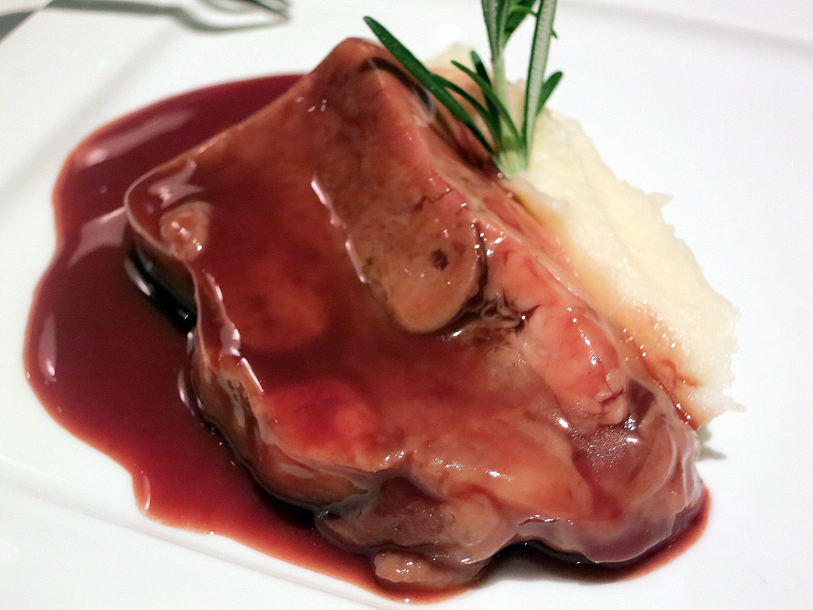 Veal tongue braised with red wine. Tender, not rubbery, with a rich