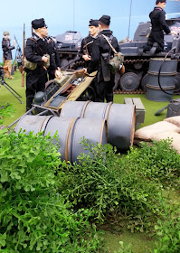 1/6 scale German soldiers in diorama of an army post on display at a scale model exhibition.