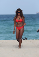 Claudia Jordan wearing a red two piece swimsuit