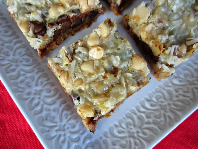 Hello Dolly bars (4) cut on a white plate ready to eat