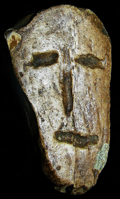 Dolní Věstonice Mask - carved Mammoth Ivory face, from Dolní Věstonice in Czech, showing asymmetry of the face