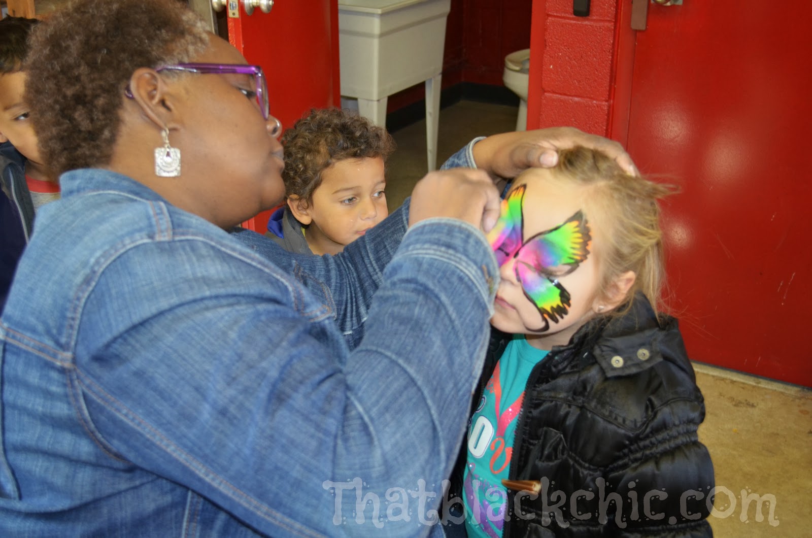Giving back by volunteering Face Painting the kiddies That Black Chic