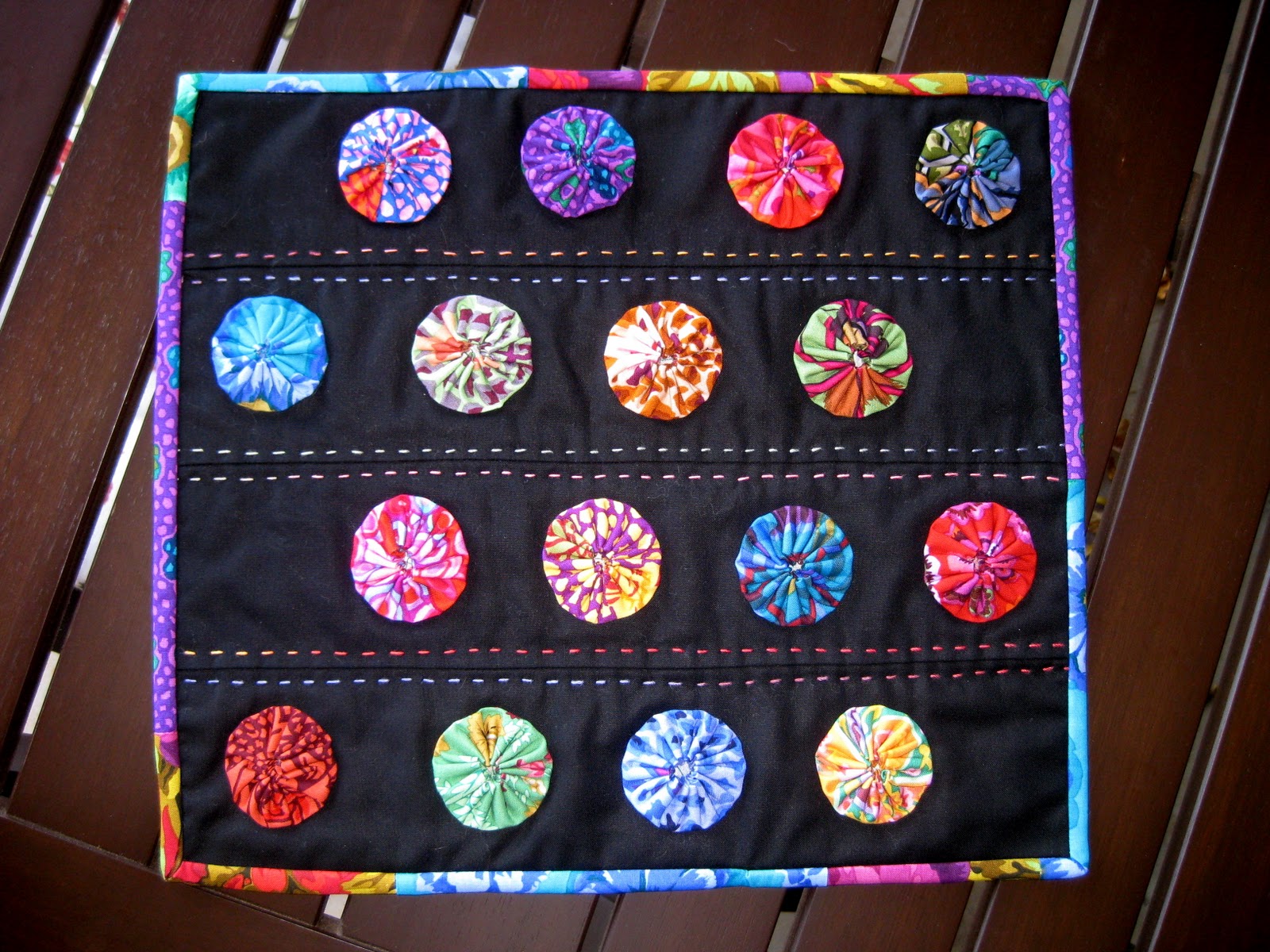 pieceful life finished yoyo mini quilt
