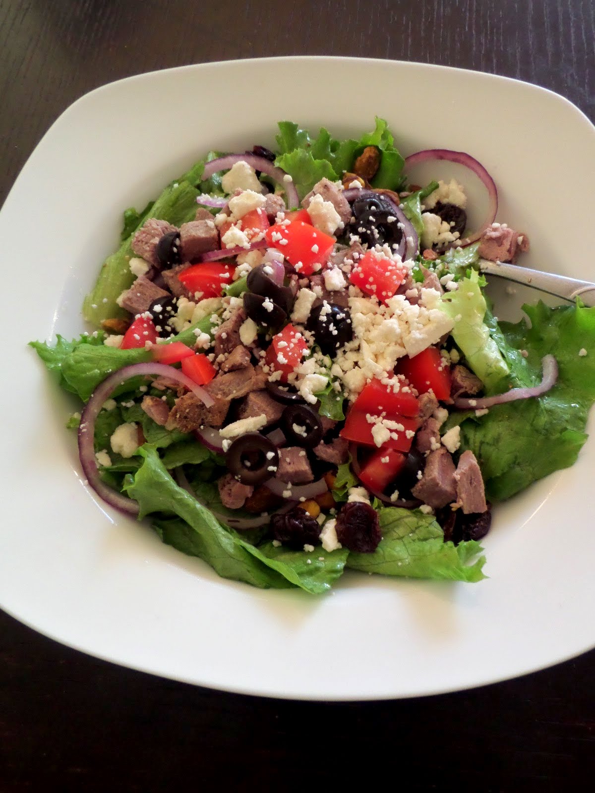 Lamb Salad:  A green salad topped with left over Herb Roasted Leg of Lamb, olives, tomatoes, and feta.