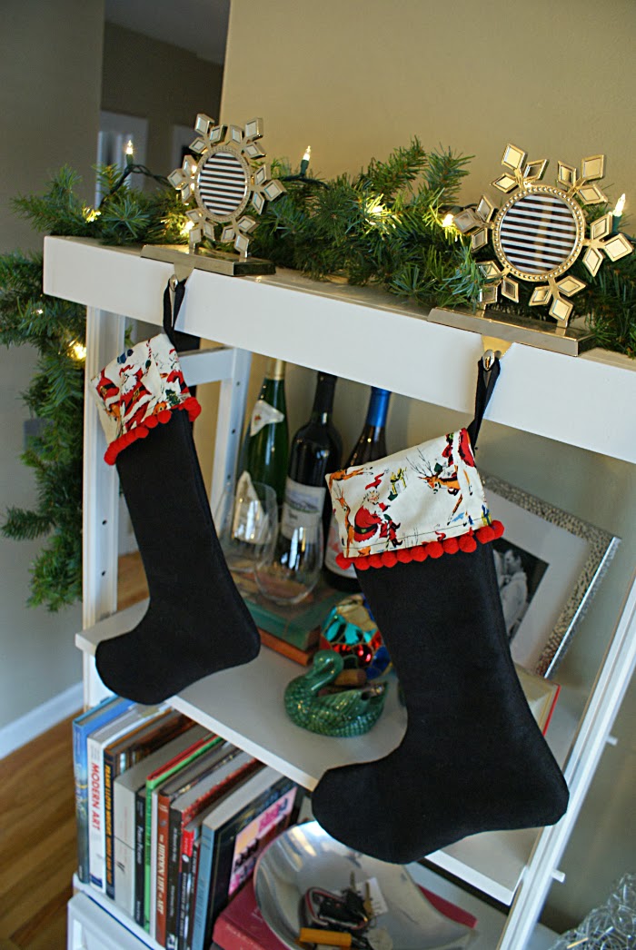 christmas stockings with red pom poms and vintage inspired fabric