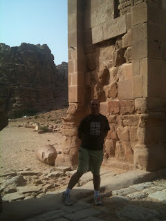 a man standing in front of a stone structure