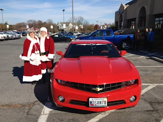 Santa Claus and Mrs Claus with Camaro Sleigh
