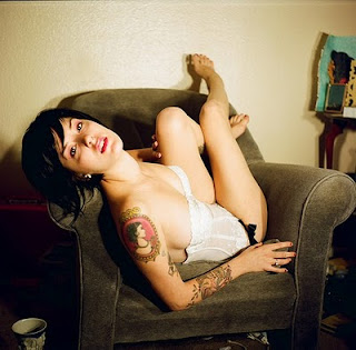 Tattooed Women with a portrait tattoo on arms