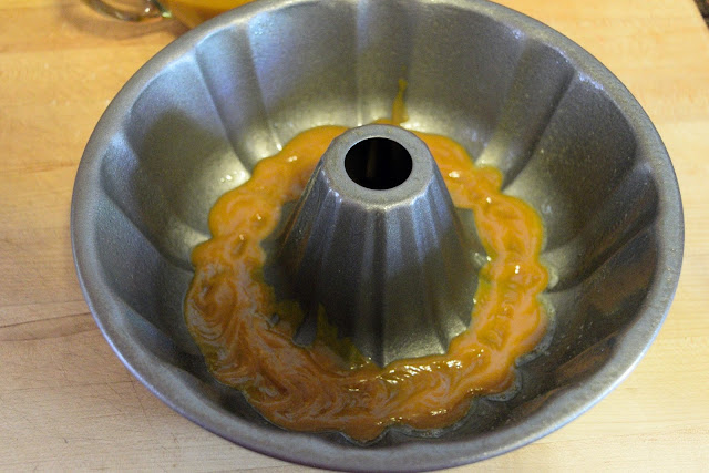 A little of the puree mixture being added to a bundt pan. 