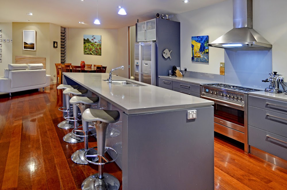 Photo of modern kitchen and kitchen island with bar chairs