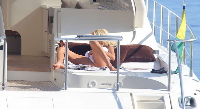 Victoria Silvstedt laying on a yacht and sending sms