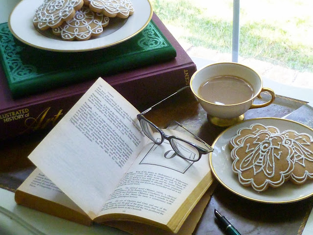 books, glasses, coffee, and honey-vanilla cookies with Napoleonic bee