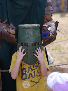 Child trying on Armor at Renaissance Festival in Deerfield Beach Child trying on Armor at Renaissance Festival in Deerfield Beach