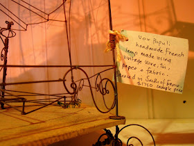 Price tag which reads 'Vox Populi handmade French lamp made using vintage wire, tin, paper and fabric. Sourced in South of France $1750 sample price.'