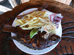 Lunch of " Tilapia fried fish with chips  " at Aero Beach resort in Entebbe