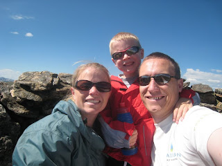 family of 3 hiking in the mountains