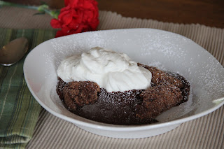 chocolate cake in a white bowl with whipped cream