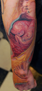 3d tattoo on the forearm: fetus tattoo