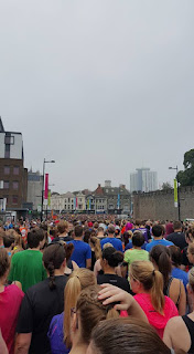 Crowds pour through the start of the Cardiff Half Marathon