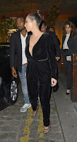Kim Kardashian wearing a low cut black outfit
