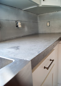 concrete counters poured right up to stainless steel apron front sink