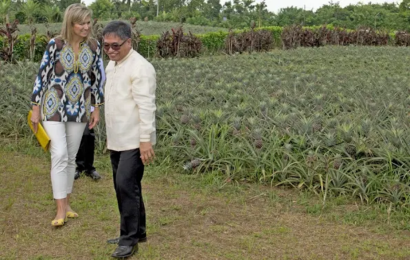 Filipino pineapple growers, during her visit at a Pineapple farm in Tagaytay City, south of Manila, Philippines