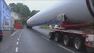 Huge wind turbine blade being transported through small town