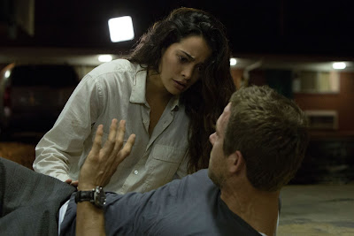 Image of Natalie Martinez and Ryan Reynolds in the sci-fi thriller Self/Less