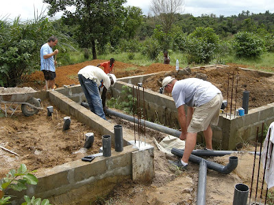 Flomo and Gordon put pipe thru wall