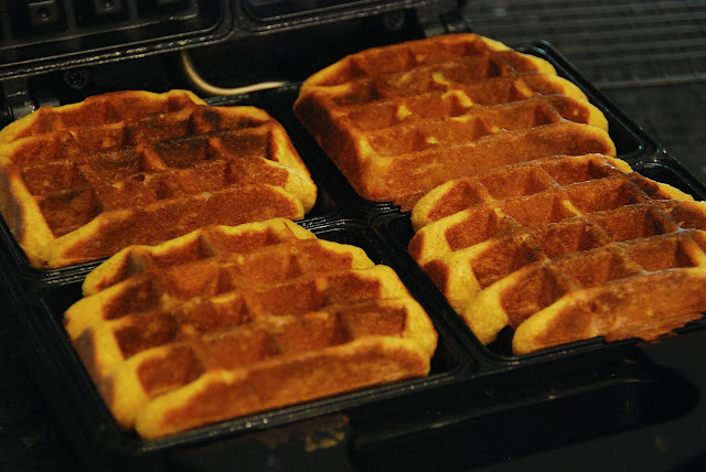 four square pumpkin waffles on open waffle iron