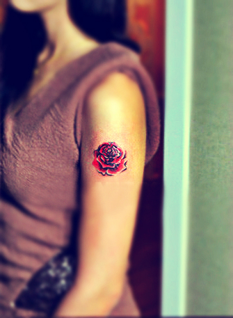 rose tattoo on the arm
