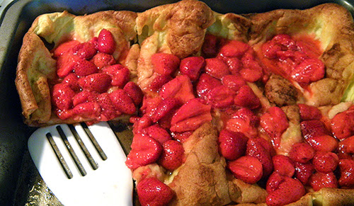 Pan of Popover Pancake with Strawberries Spooned on