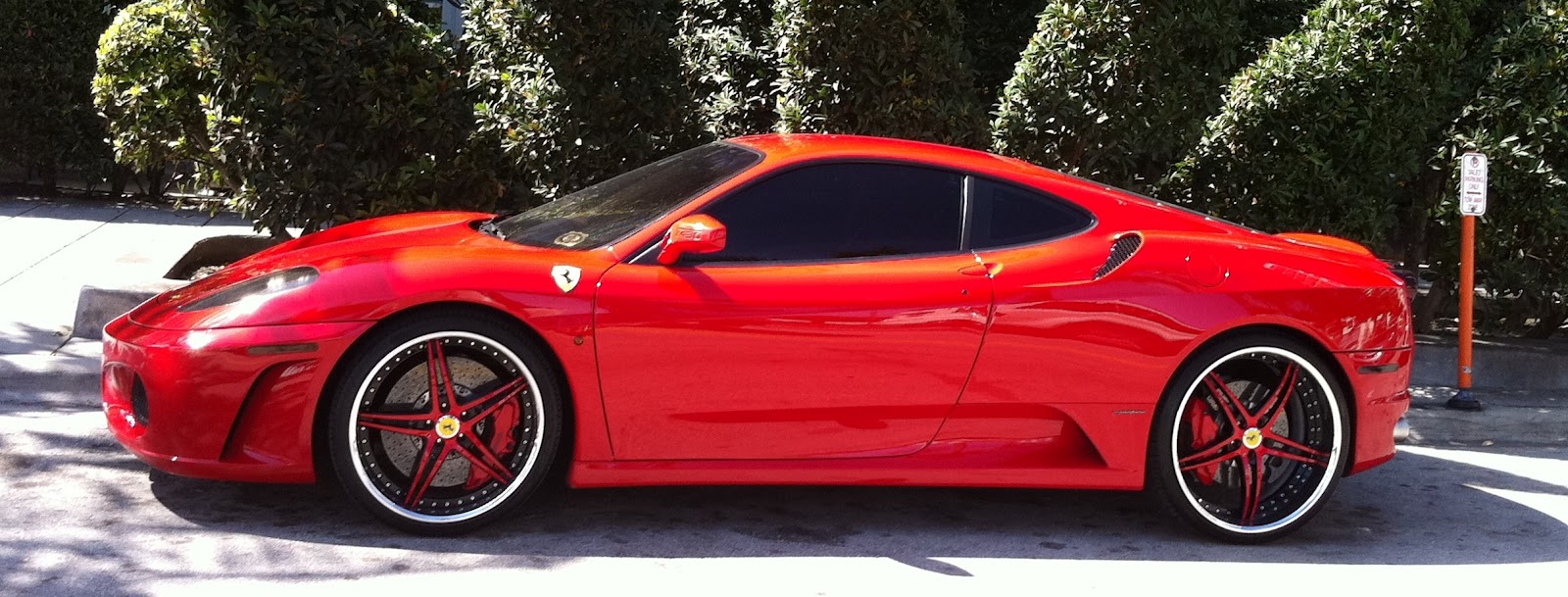 Red Ferrari f430 in Midtown Miami with red and black custom rims 