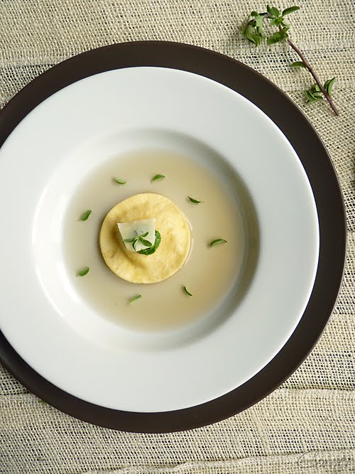 Almond Corner Roasted Potato Peel Consommé with Quail Egg Ravioli and