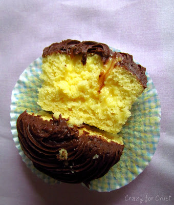cupcakes cut in half and filled with pudding and chocolate frosting