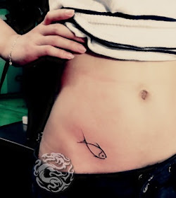 small fish tattoo on the hip