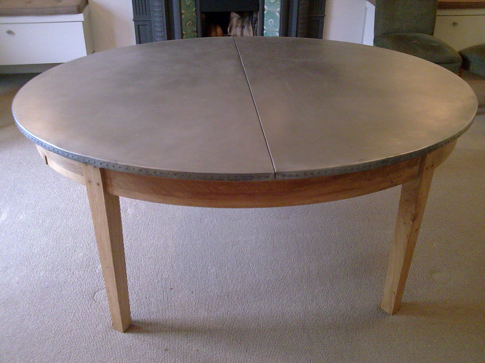 Deballage Designs Oval oak table with a studded zinc top