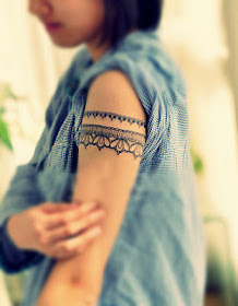 Lace tattoo around the arm