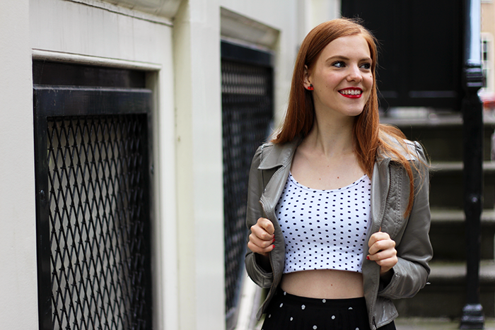 Vintage fashion blogger outfit with a polka dot crop top and a grey faux leather jacket