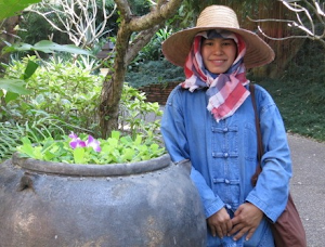 Staff member Sorn refreshing the beautiful floating flower displays at the Four Seasons Chiang Mai