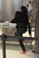 Kim Kardashian taking off her golden shoes